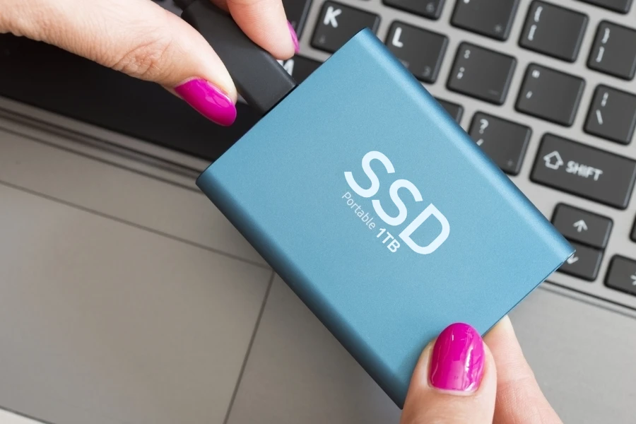 lady holding a blue portable 1tb ssd