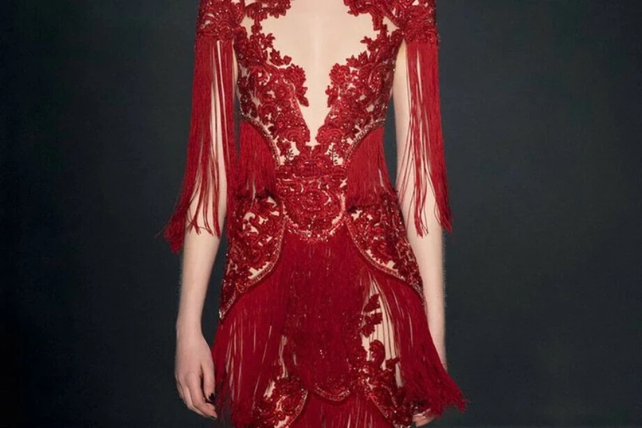 Lady on a catwalk dressed in a red beaded dress