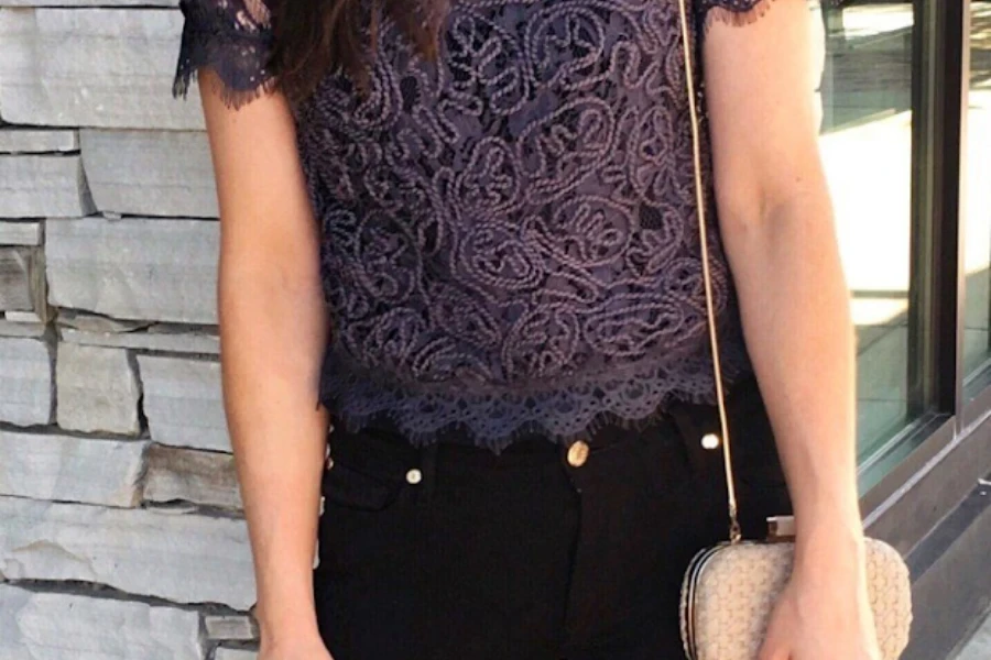 Lady rocking a purple lace top and black jeans