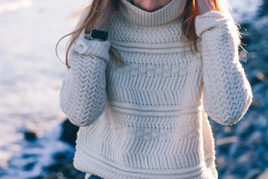 Lady wearing a knitwear and denim outfit