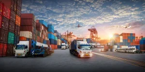 Logistics and transportation of container cargo ship and cargo plane with working crane bridge in shipyard at sunrise