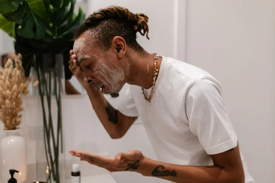 Man applying moisturizer to his face