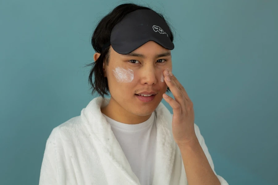 Man applying retinol before bed