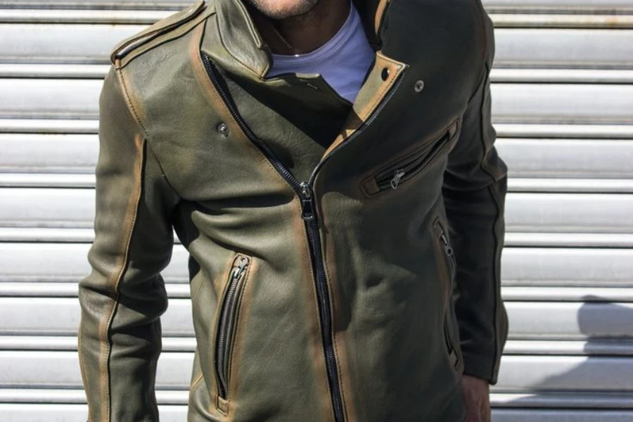 Man posing in a distressed leather jacket