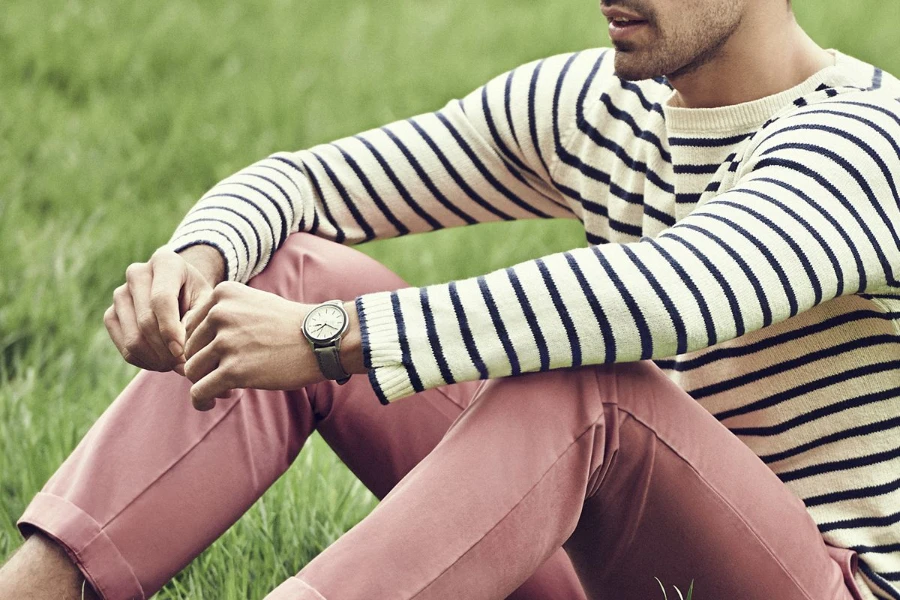 Man sitting on the grass in a horizontal-striped tee