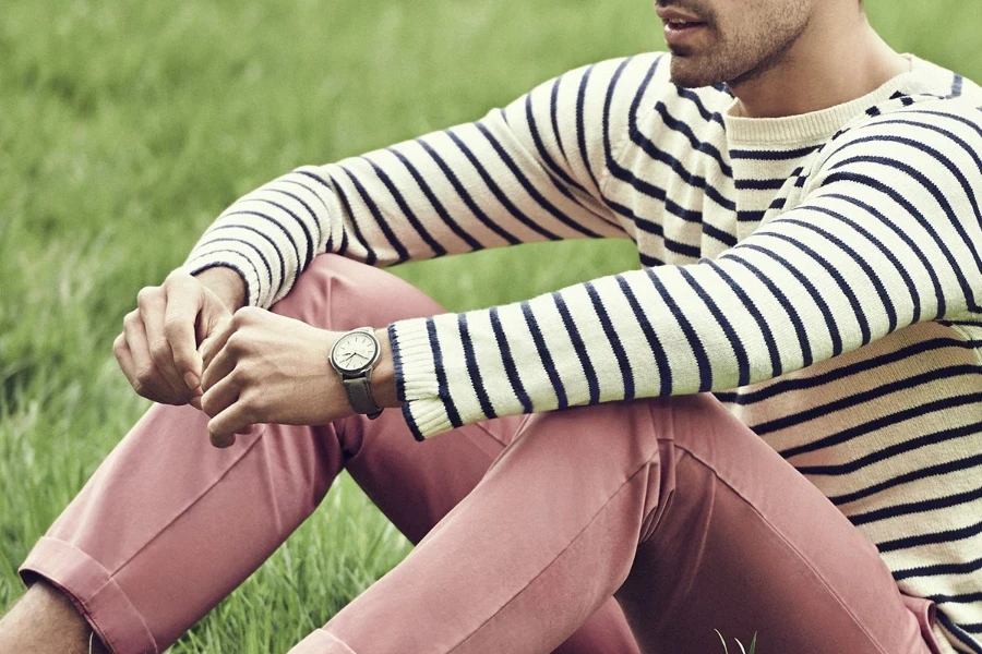 Man sitting on the grass in a horizontal-striped tee