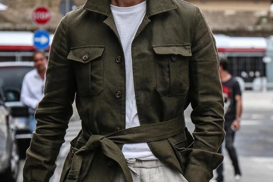 Man with hands in pocket in a striking safari jacket