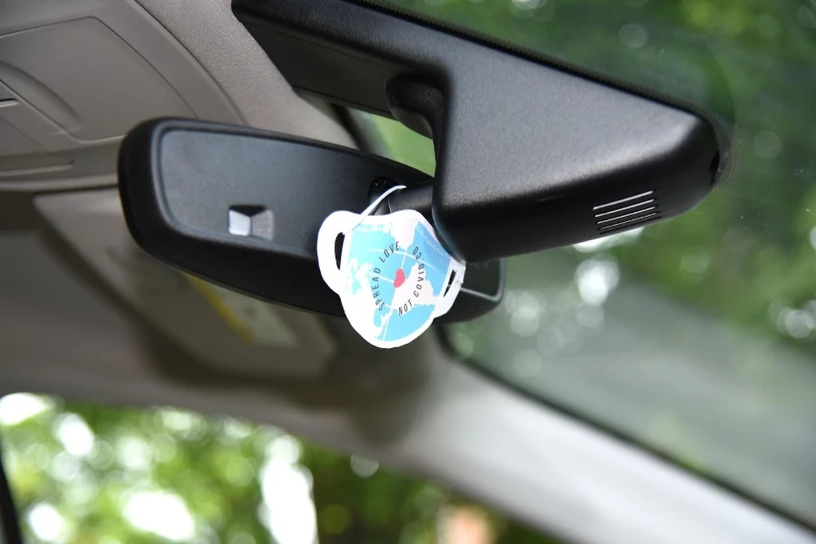 Paper car air freshener behind car's mirror