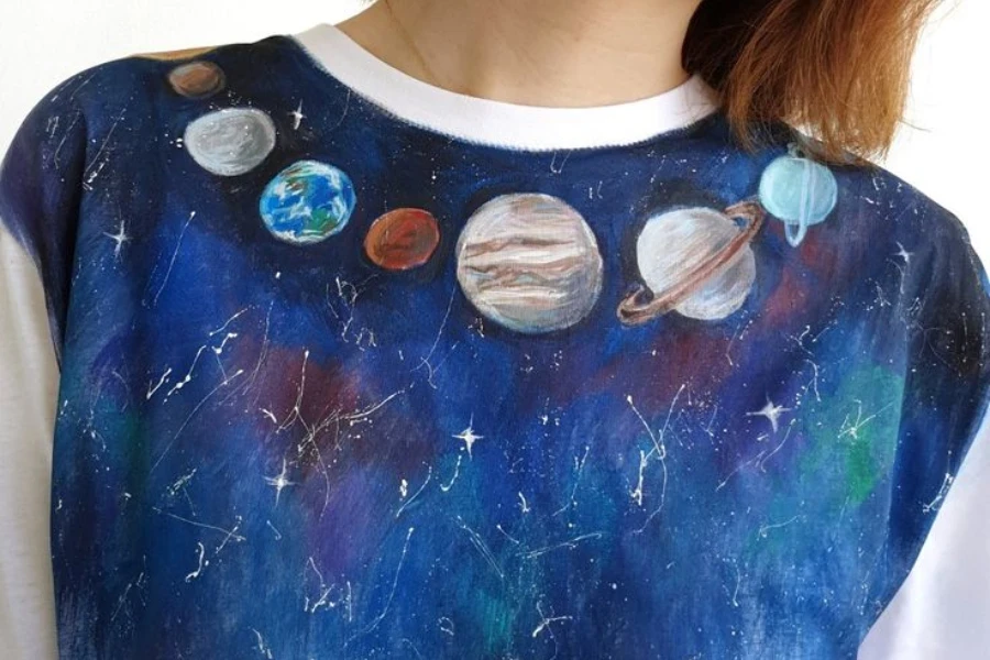 Person wearing a solar-system themed shirt