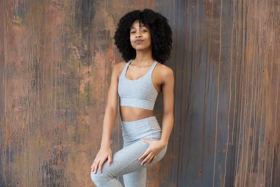 Sexy woman rocking gray high-waist leggings and bra top