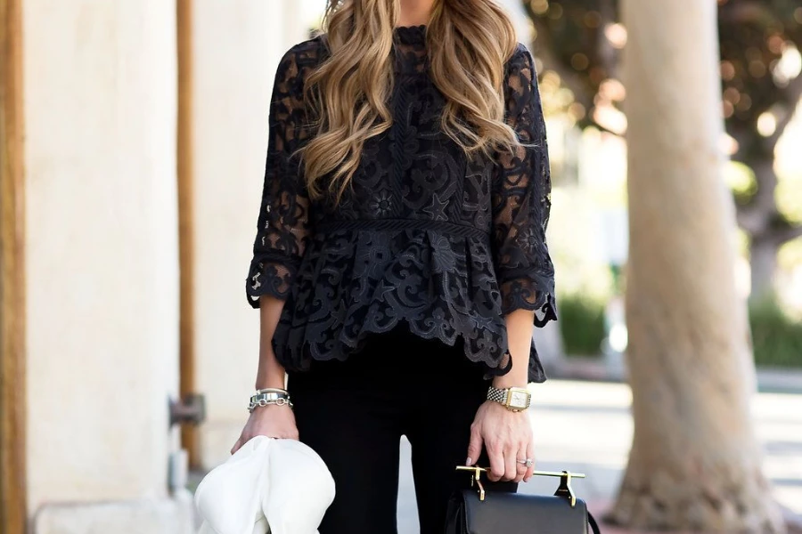 Standing lady in a black lace top and black jeans