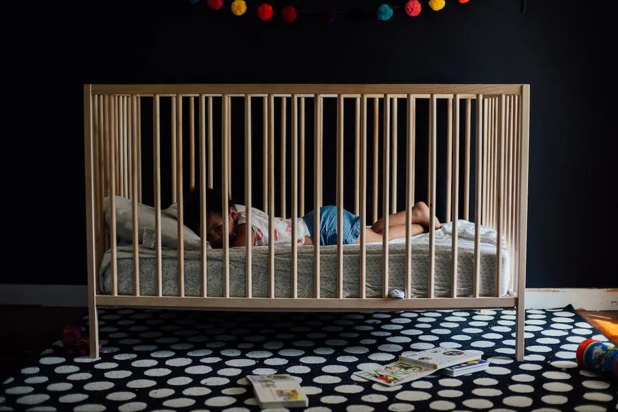 Toddler in a safe crib