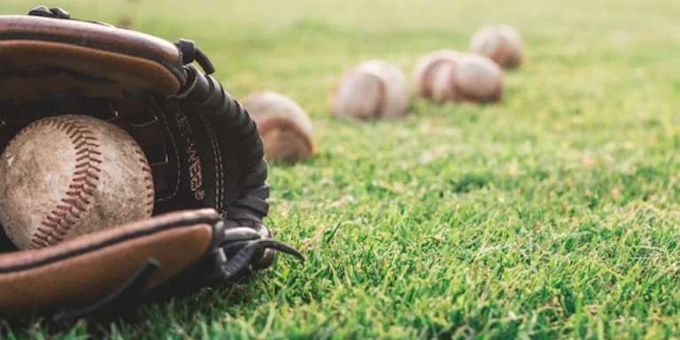 White baseball ball on brown leather glove