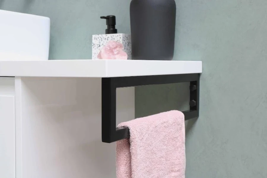 White bathroom counter with black towel rack