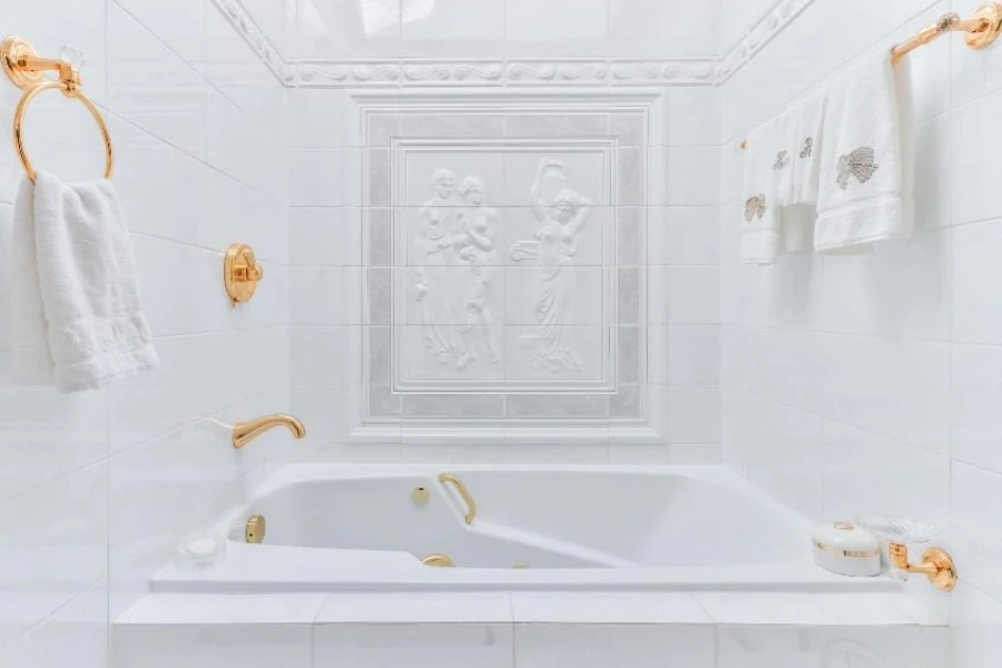 White bathroom tub with gold fittings