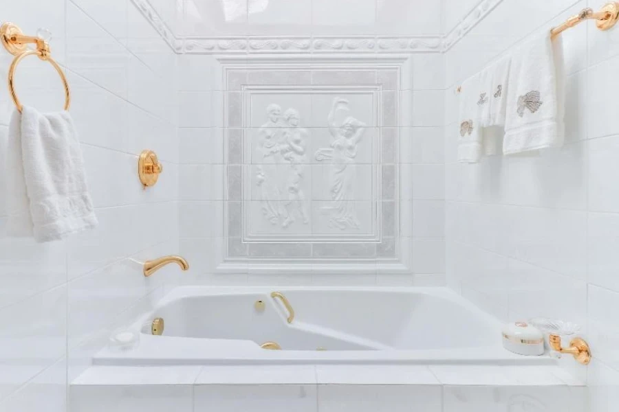 Weiße Badezimmerwanne mit goldenen Armaturen