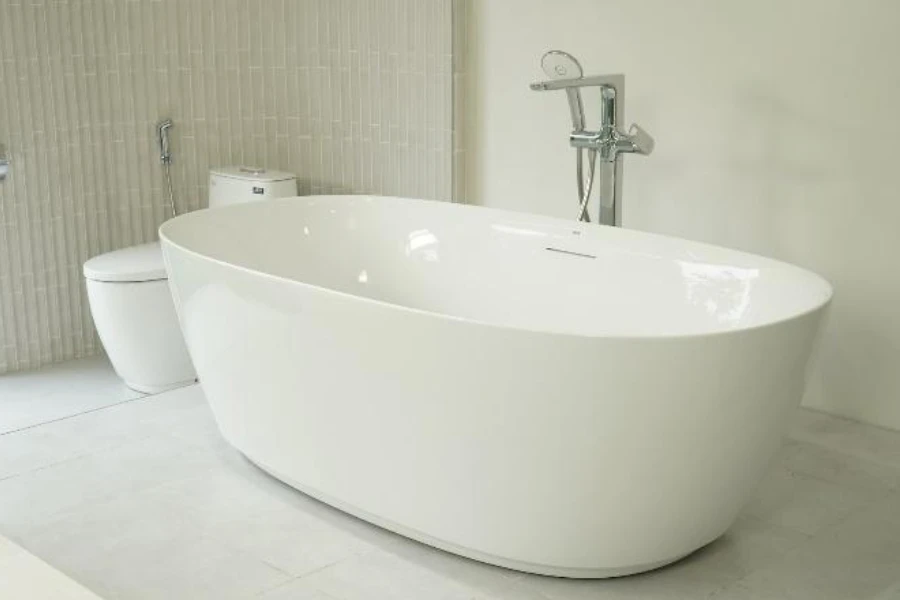 White freestanding soaking tub with chrome tub filler