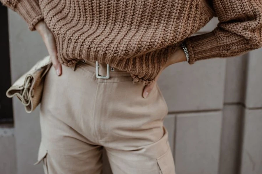 Woman in a chunky sweater and cargo pant combo