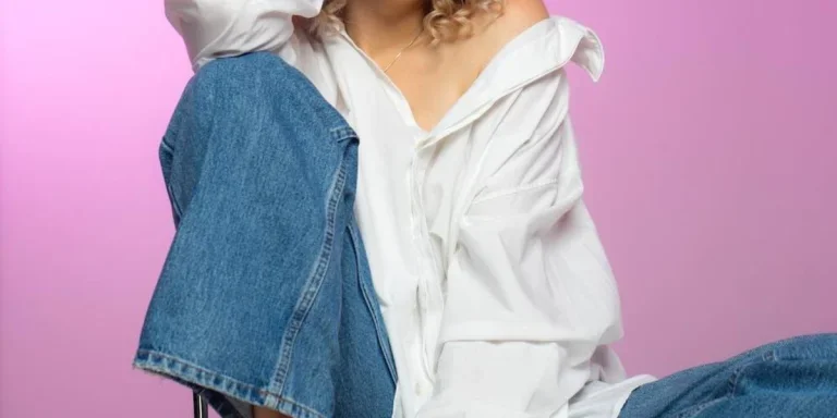 Woman in an oversized white shirt and denim jeans