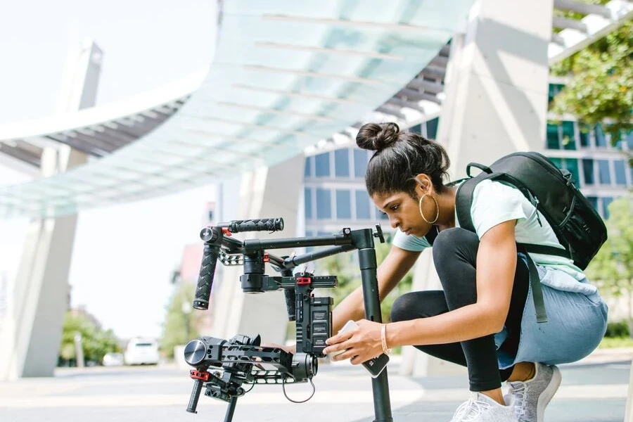 Woman in tank-top holding camera