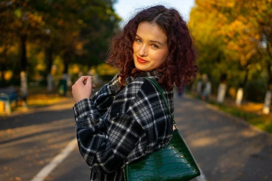 Woman posing in gray plaid shirt