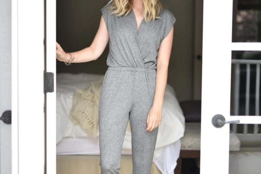 Woman rocking a cashmere jumpsuit in a bedroom