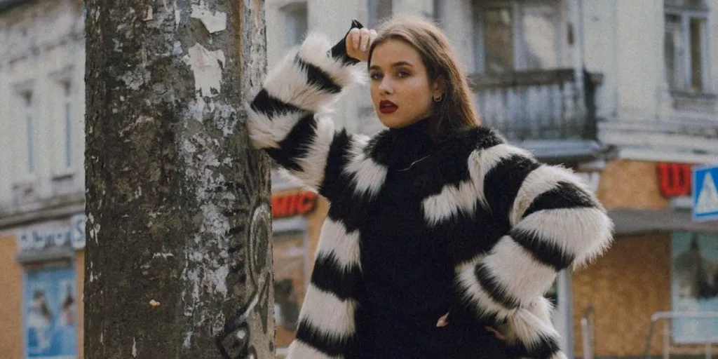 Woman wearing a white and black striped fur jacket