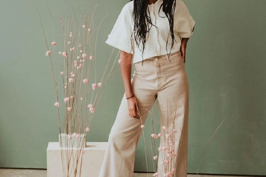 Woman wearing a white shirt with high-waisted tailored trousers