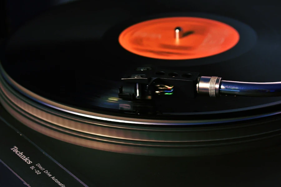 A belt drive turntable playing a record