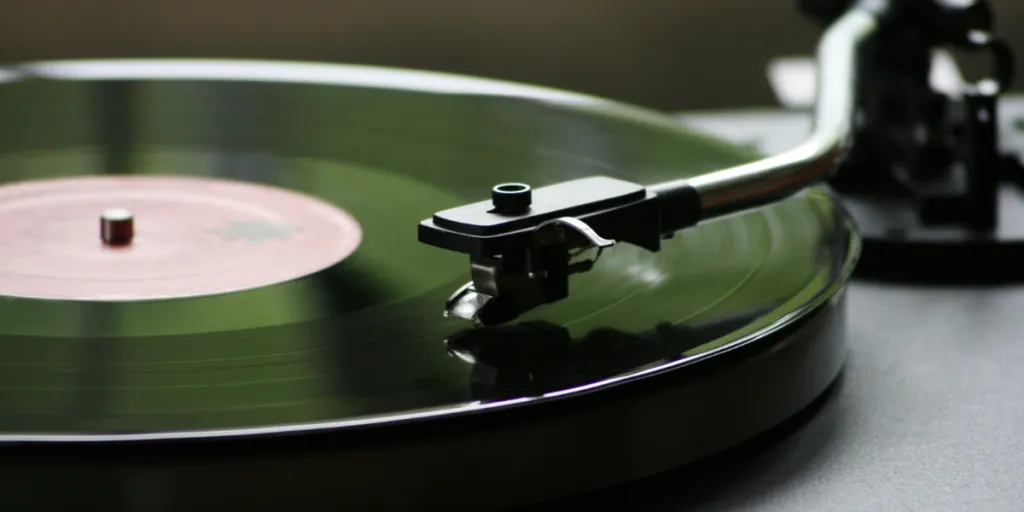 A green turntable without a vinyl record