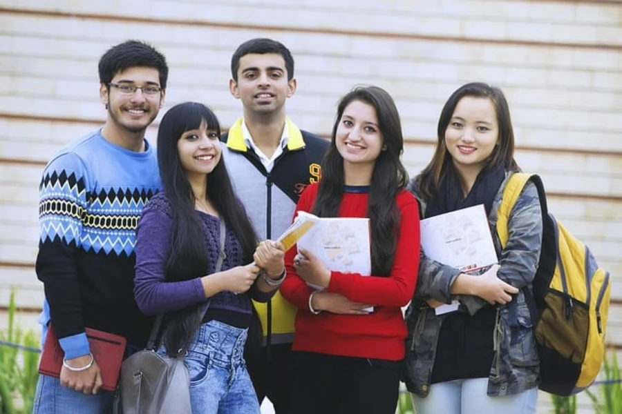 A group of college students holding books