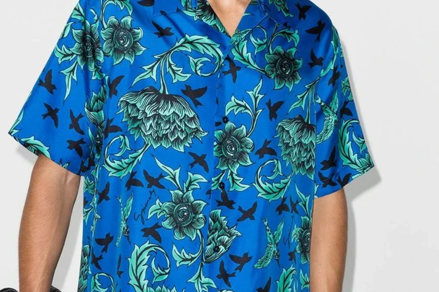 A man rocking a blue tiki-inspired bowling shirt