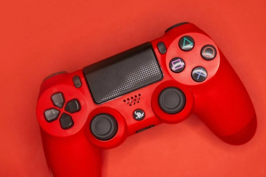 a red and black ps4 game controller