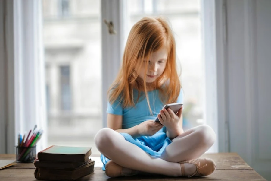 a young girl holding a smartphone