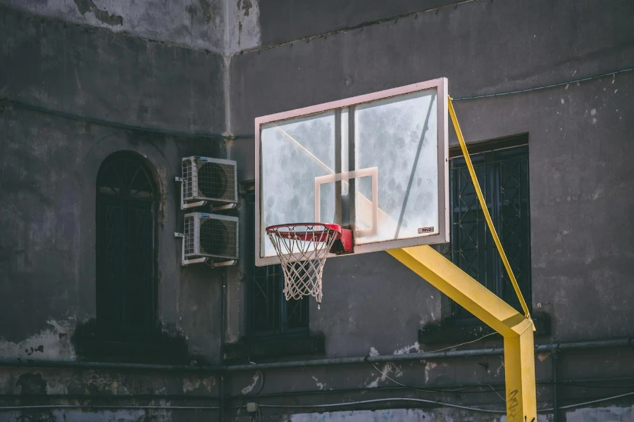 An in-ground outdoor basketball hoop