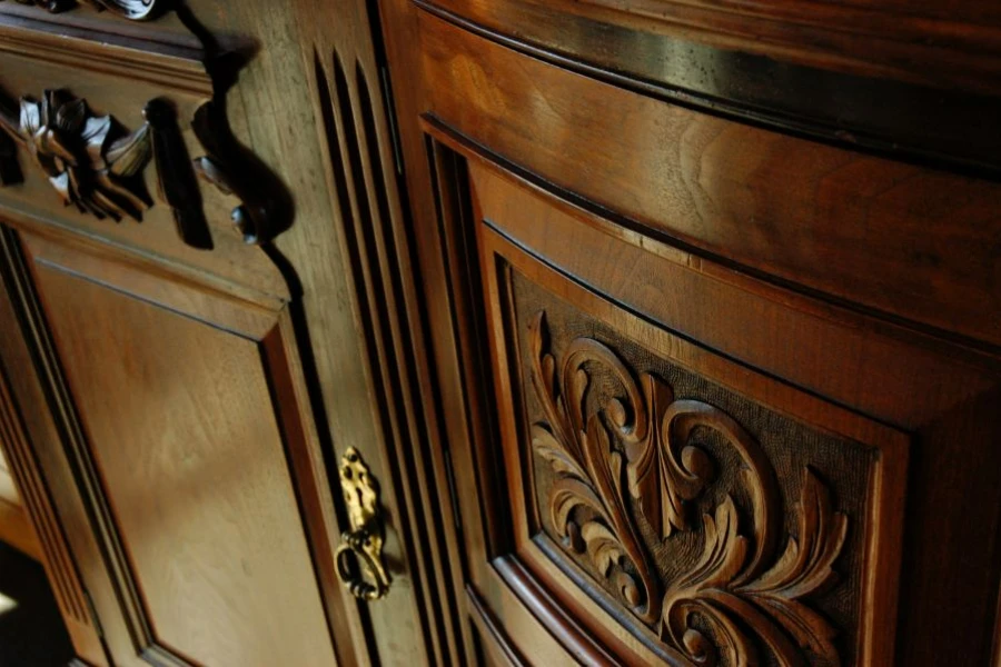 An ornate polished carved wood cupboard