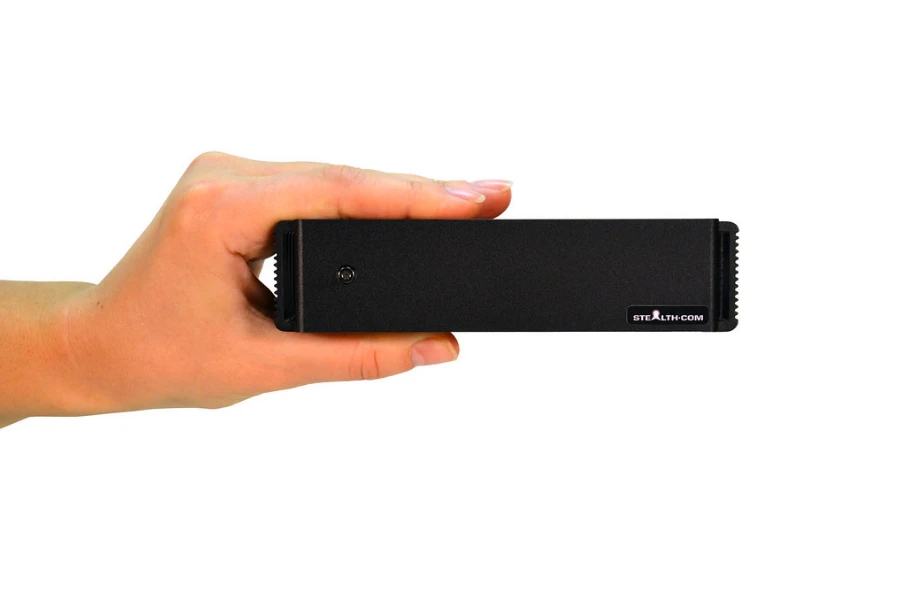 anonymous hand holding a black mini pc