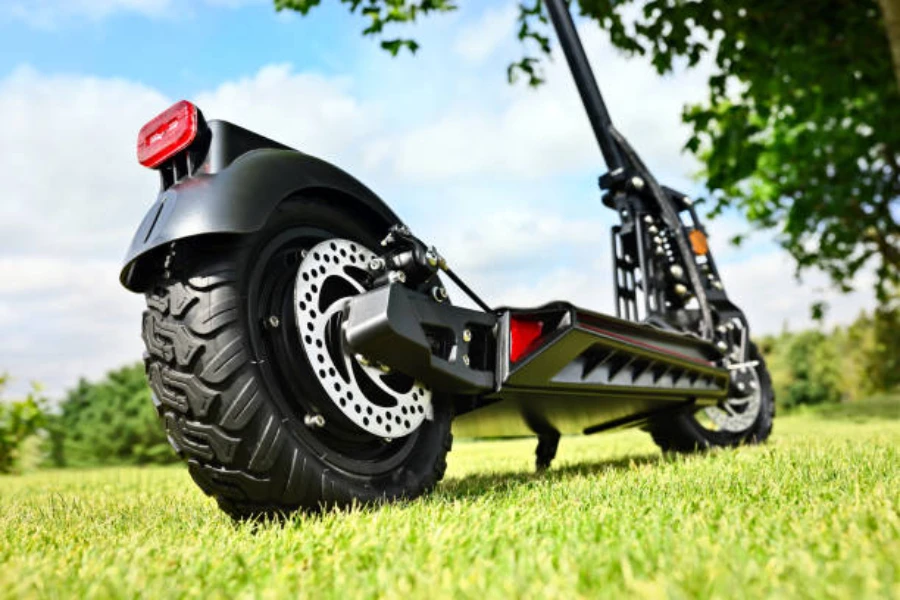 Black scooter with all terrain wheels and kick stand