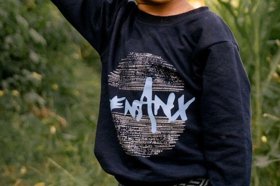 Boy posing in graphic blue sweatshirt