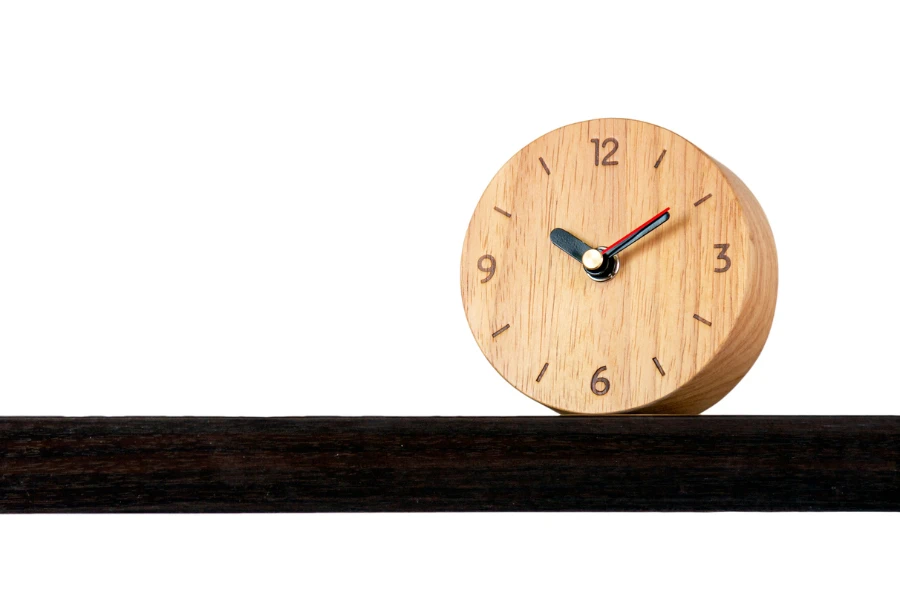 Brown alarm retro classic wooden design clock placing on shelf with ten o'clock isolated white background