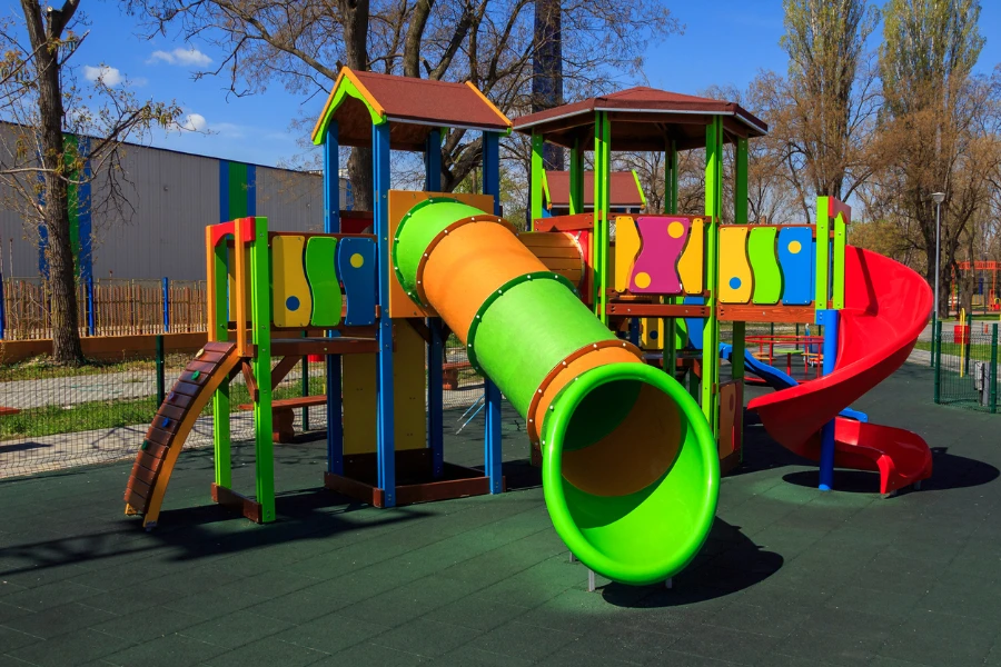 Colorful jungle gym with large straight tube slide attached