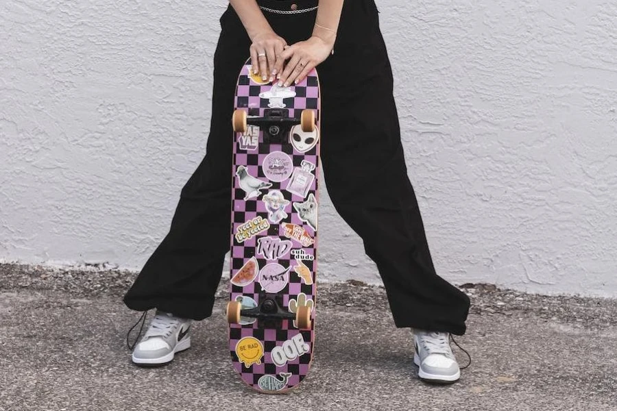 Cropped picture of a skater girl in black oversized trousers