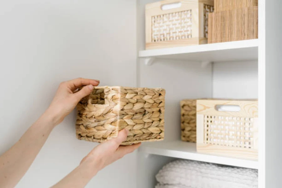 hands placing wicker basket on shelf