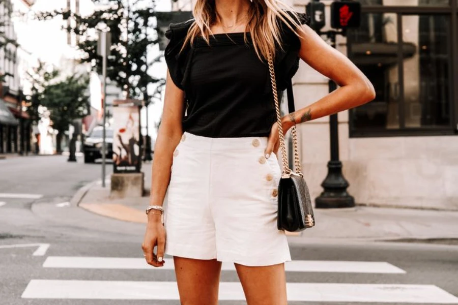 Lady in white shorts with hands on her waist