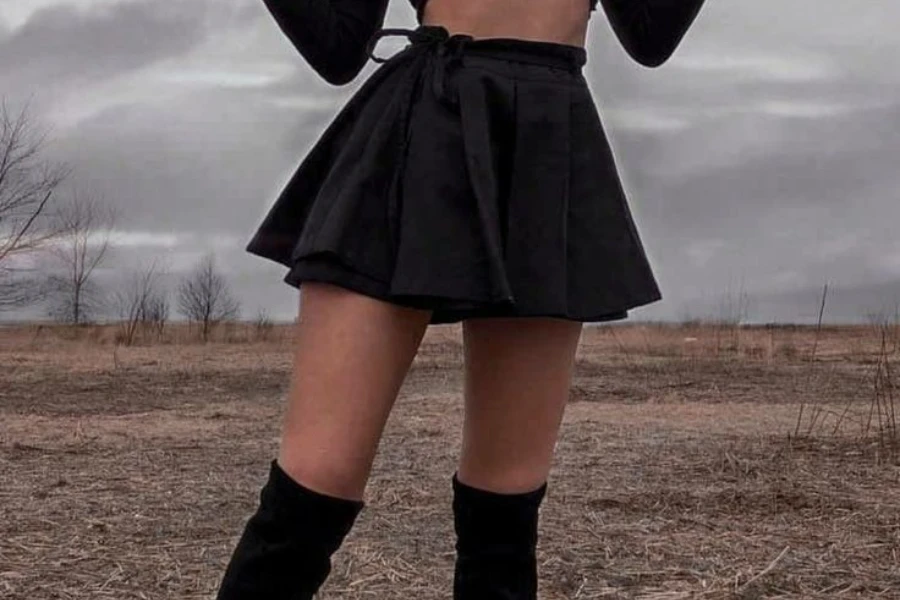 Lady showcasing a black mini skater skirt