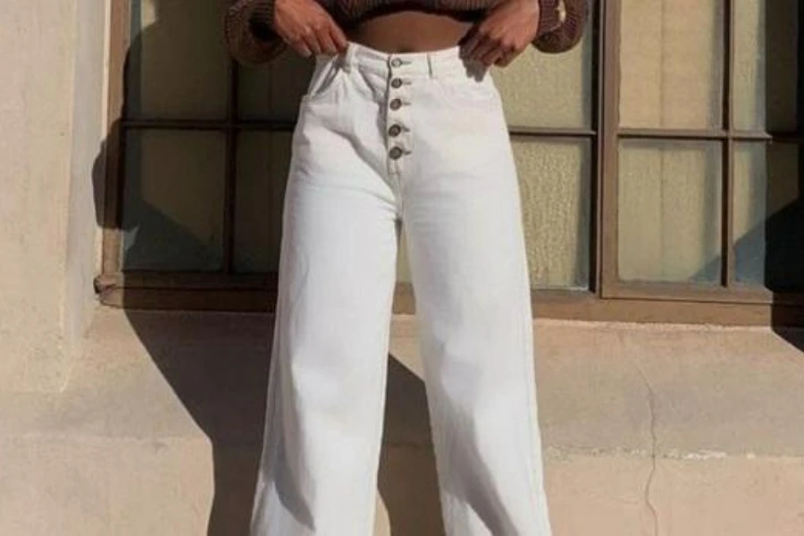 Lady showing off a pair of white trousers