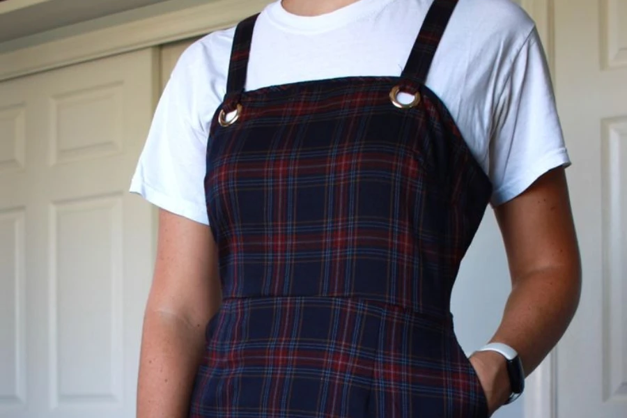 Lady wearing a red and black plaid apron dress