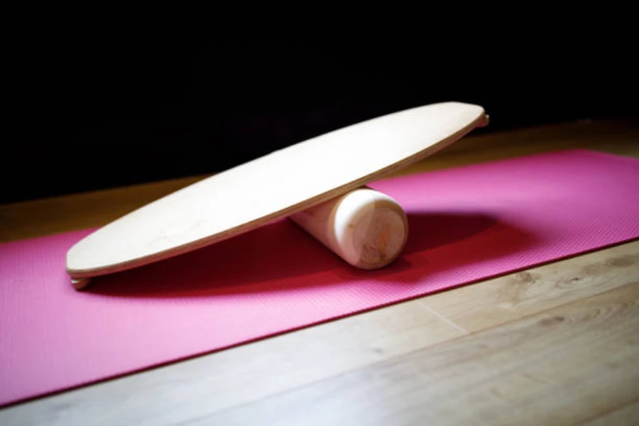 Light wood indo board sitting on a pink yoga mat
