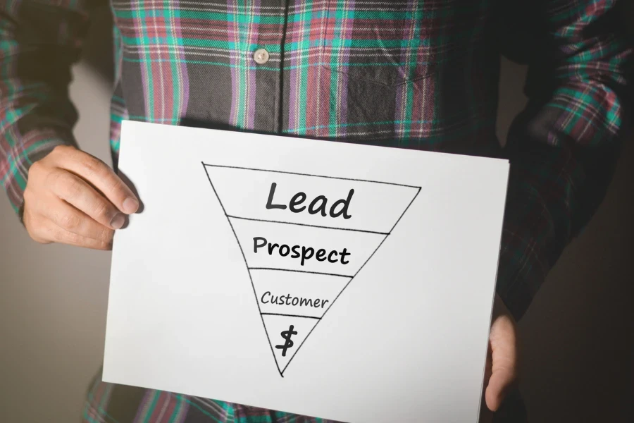 Man holding a sales funnel sketch