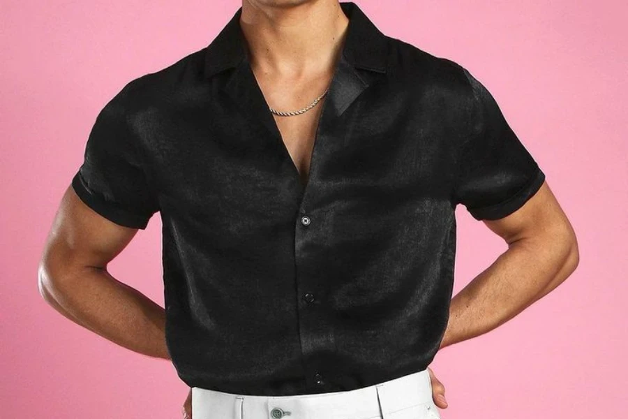 Man posing in a black silk shirt